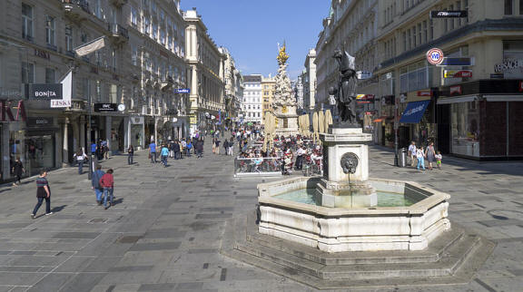 Vibrant Naschmarkt Vienna square with central ornate fountain, shoppers, and historic shops